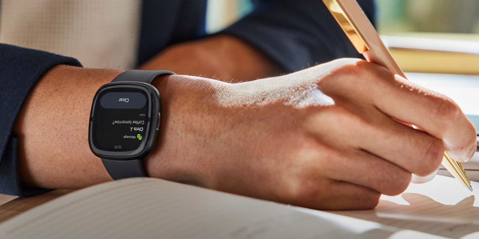 /sv/images/a-guy-taking-notes-wearing-a-fitbit-sense-2.jpg