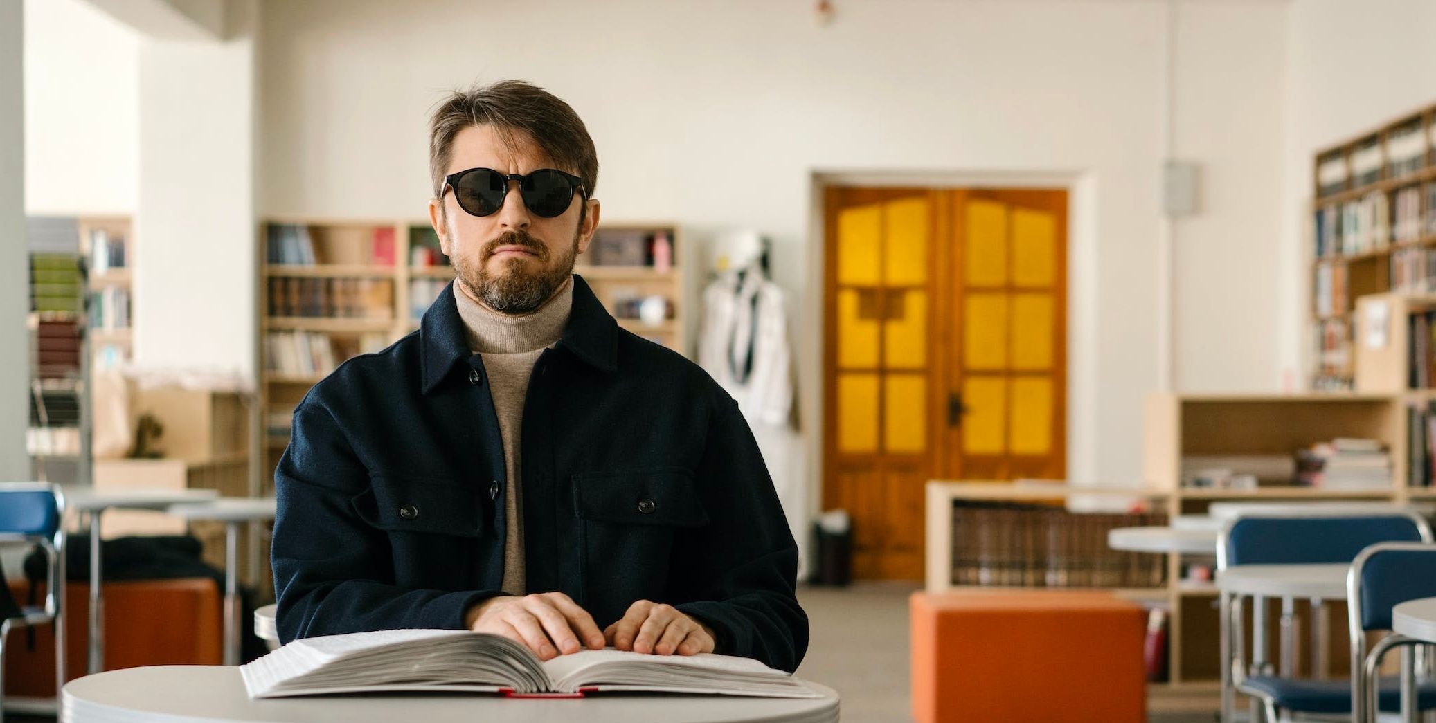 /sv/images/a-man-wearing-sunglasses-touching-an-open-book.jpg