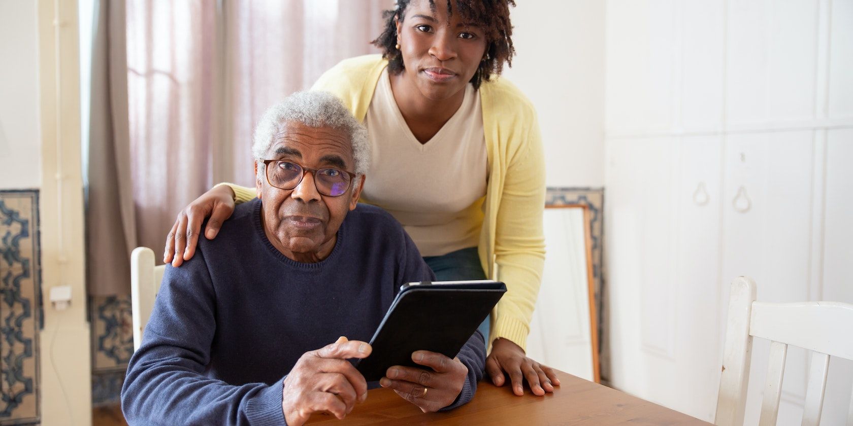 /th/images/a-woman-standing-beside-the-elderly-man-holding-a-tablet-and-staring-at-the-camera.jpg /th/images/a-woman-standing-beside-the-elderly-man-holding-a-tablet-and-staring-at-the-camera.jpg