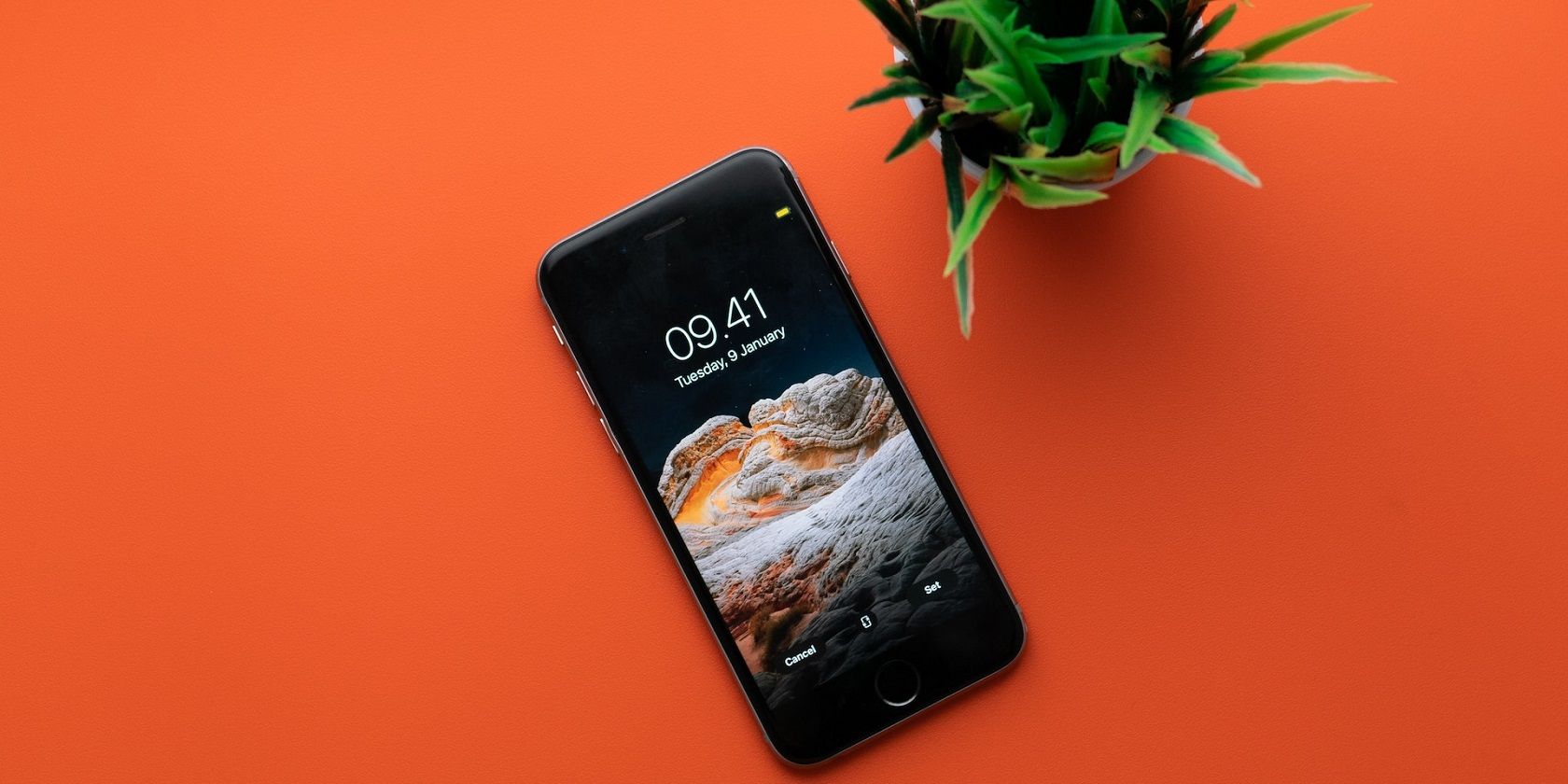 /th/images/image-of-phone-on-orange-background-with-mini-plant.jpg