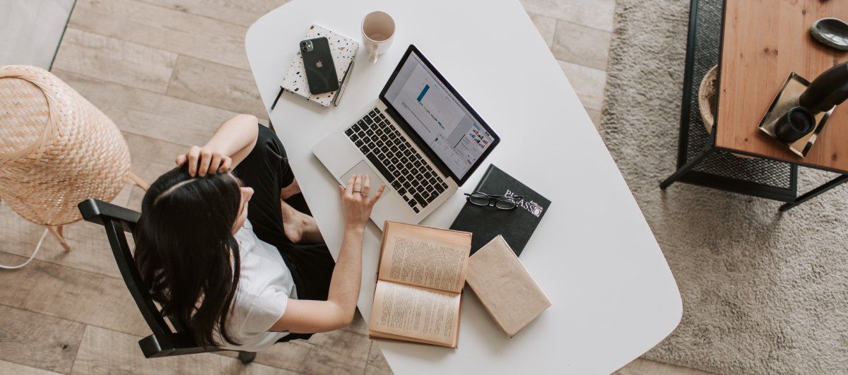/th/images/woman-on-laptop-with-books-and-a-cup-on-the-desk.jpg